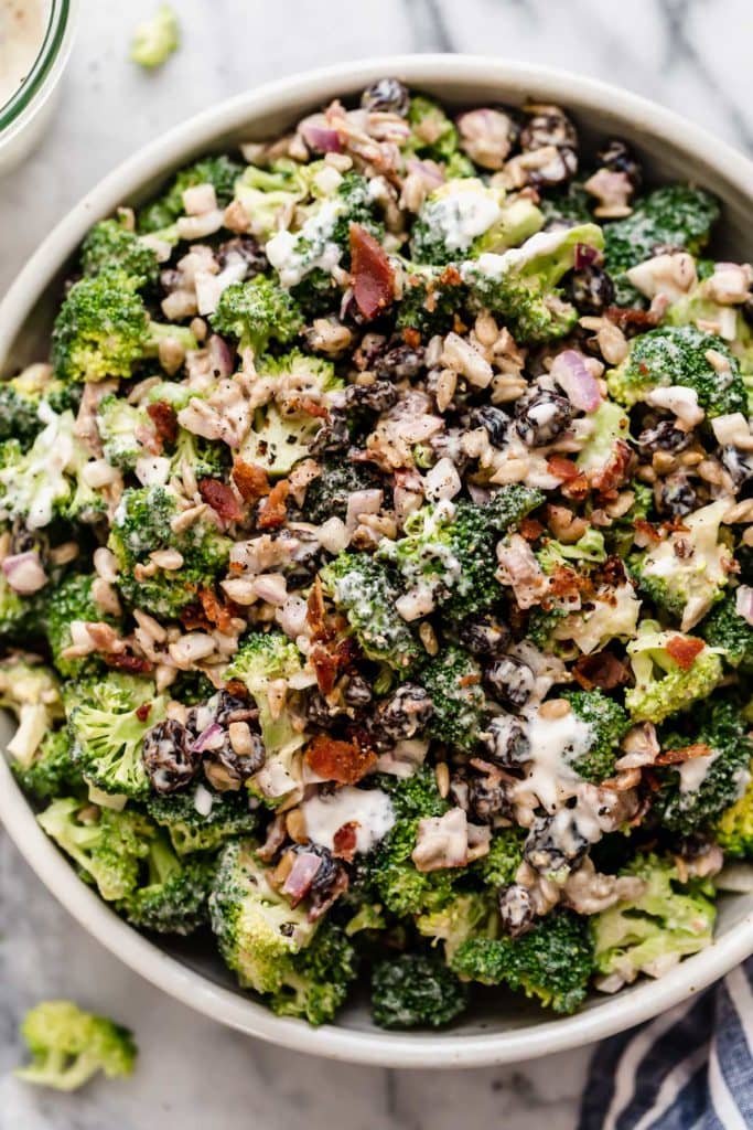 Overhead view creamy broccoli salad in large serving bowl