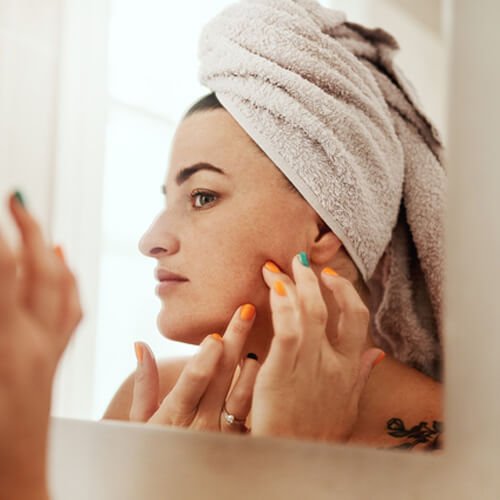 woman looking at mirror